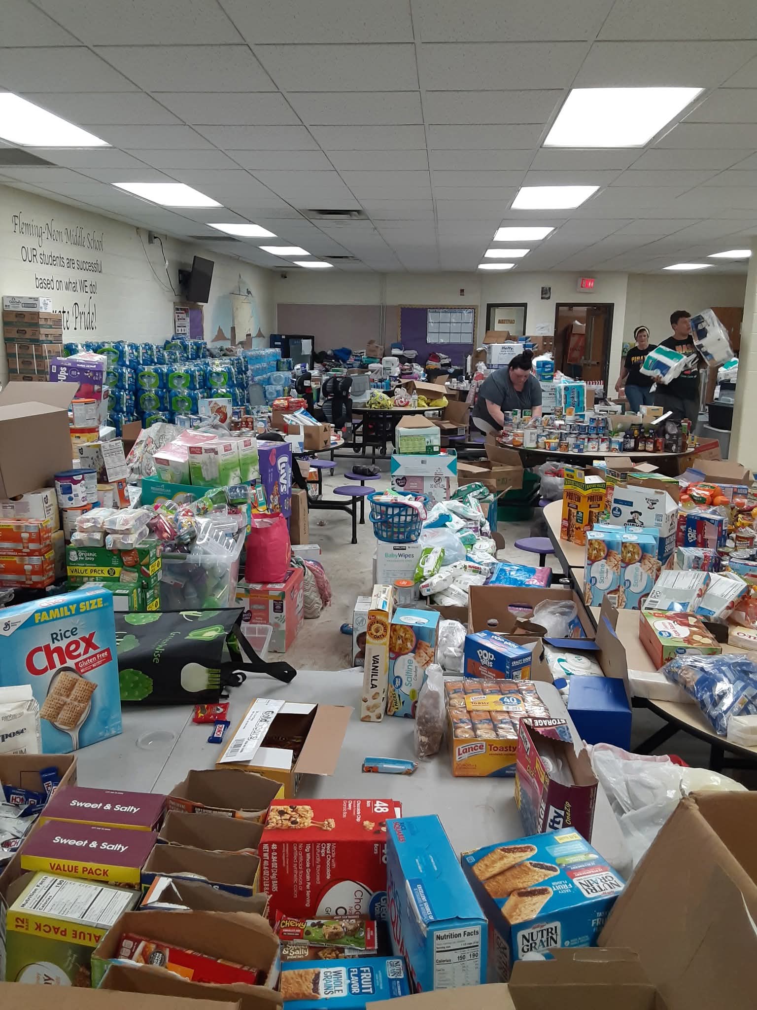 Volunteers sorting food, water and supplies inside a school gym after Eastern Kentucky flooding