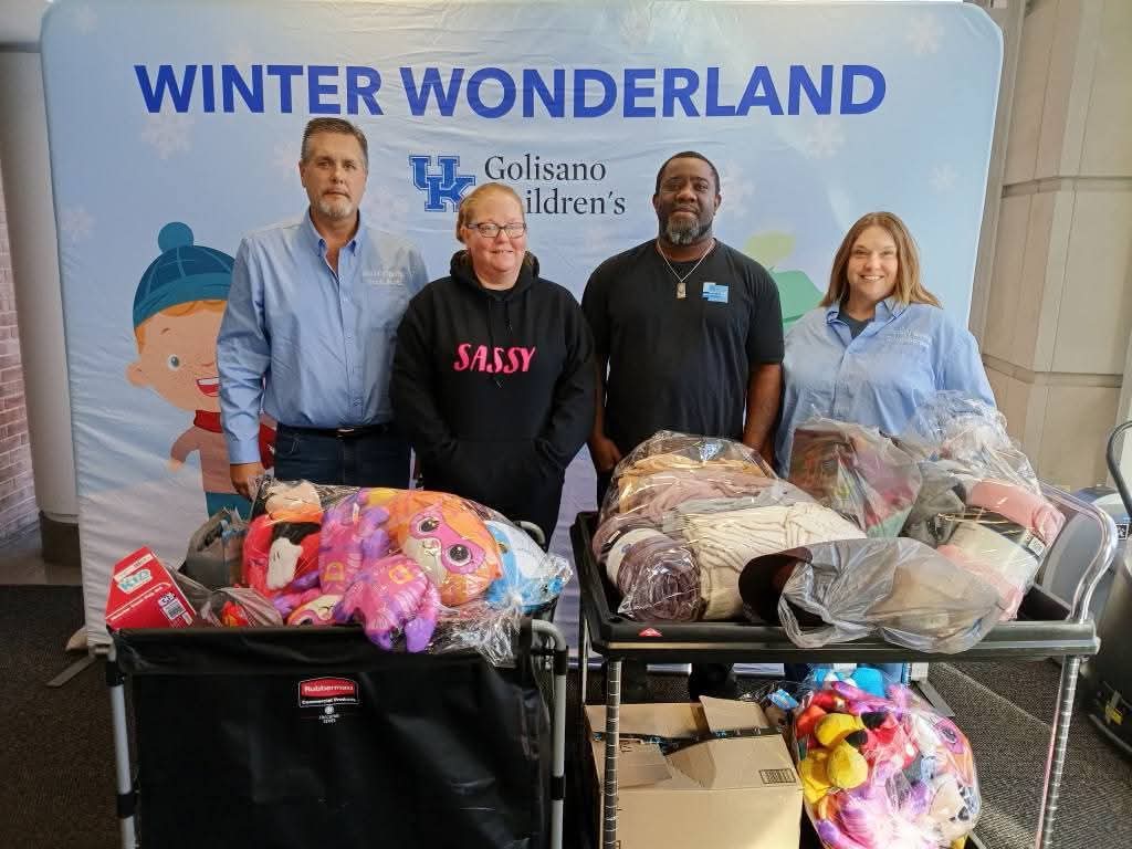 Volunteers delivering carts of plush toys and blankets at the UK Golisano Children's Hospital Winter Wonderland event